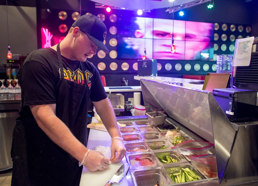 Sushi chef Peter Reisterer III prepares a Metalhead Roll at the new Rock n Roll Sushi restaurant at the Nine Mile Crossing shopping plaza in Beulah on Friday, July 2, 2021.